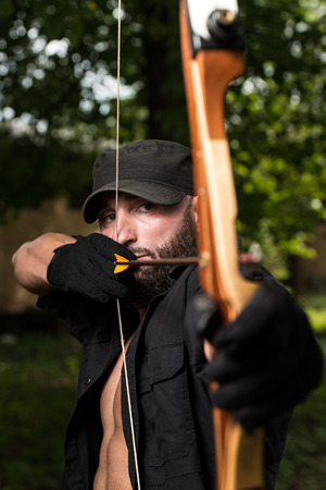 Beard Man With A Bow And Arrows In The Woodsの写真素材