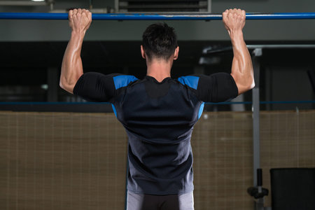 Male Fitness Athlete Doing Heavy Weight Exercise For Back