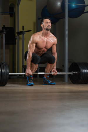 Male Fitness Athlete Lifting Deadlift In The Gymの写真素材