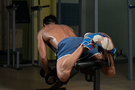 Male Fitness Athlete Doing Heavy Weight Exercise For Back