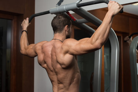 Male Fitness Athlete Doing Heavy Weight Exercise For Back