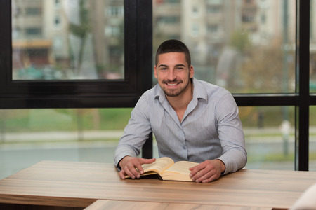 A Portrait Of An Caucasian College Student Man In Library - Shallow Depth Of Fieldの写真素材