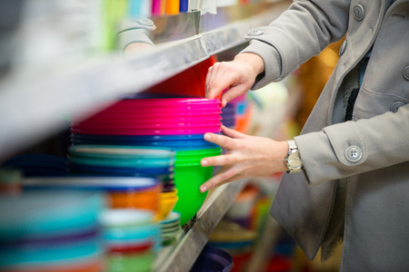 Beautiful Young Woman Shopping For Bowl In A Grocery Storeの写真素材