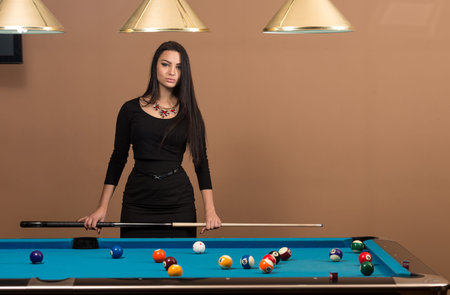 Portrait Of A Young Woman Playing Billiards
