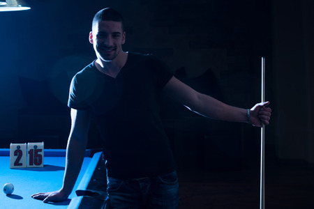 Portrait Of A Young Man Playing Billiardsの写真素材