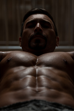 Mexican Bodybuilder Working Out Chest - Dumbbell Concentration Curlsの写真素材