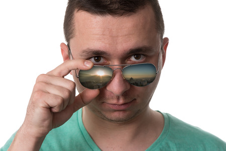 Young Man Wearing A Green T-Shirt And Sunglasses - Isolated Over White Backgroundの写真素材