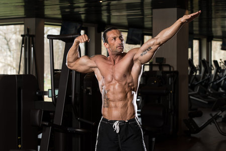 Portrait Of A Physically Fit Man In Modern Fitness Center