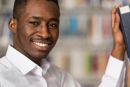 Portrait Of A College Student Man In Library - Shallow Depth Of Fieldの写真素材
