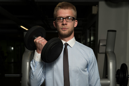 Businessman Working Out Biceps - Dumbbell Concentration Curlsの写真素材