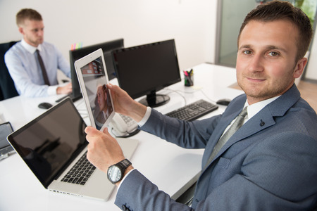 Happy Young Business Men Work In Modern Office On Computerの写真素材