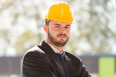 Portrait Of Business Man With Yellow Helmet On Constructionの写真素材