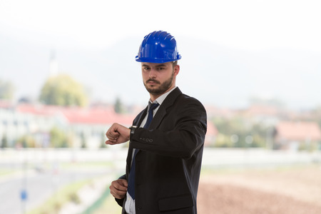 Businessman Looking At The Time On His Wrist Watchの写真素材
