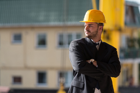Portrait Of Business Man With Yellow Helmet On Constructionの写真素材