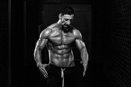 Portrait Of A Physically Fit Man Showing His Well Trained Bodyの写真素材