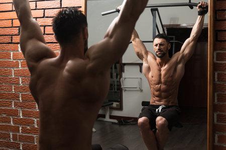 Healthy Man Exercising His Abs At The Gym