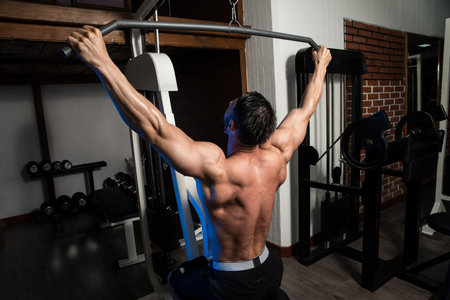 Bodybuilder Doing Heavy Weight Exercise For Back