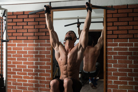 Healthy Man Exercising His Abs At The Gym