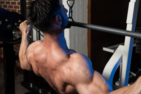 Bodybuilder Doing Heavy Weight Exercise For Back
