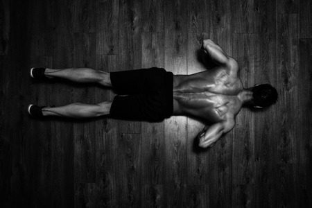 Healthy Athlete Doing Push Ups As Part Of Bodybuilding Trainingの写真素材