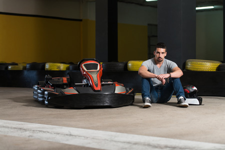 Young Man Is Driving Go-Kart Car With Speed In A Playground Racing Track - Go Kart Is A Popular Leisure Motor Sportsの写真素材