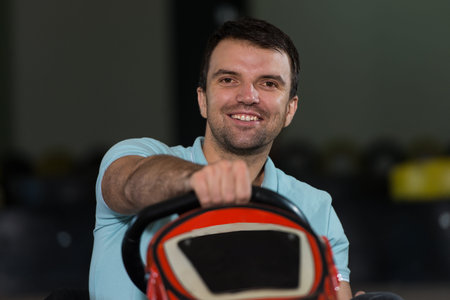 Young Man Is Driving Go-Kart Car With Speed In A Playground Racing Track - Go Kart Is A Popular Leisure Motor Sportsの写真素材