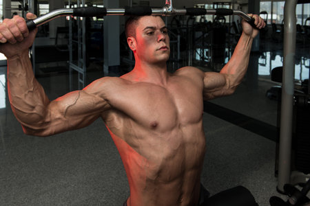 Young Bodybuilder Doing Heavy Weight Exercise For Back