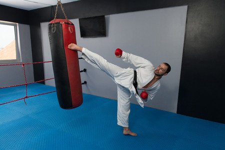 Young Man Practicing His Karate Moves - White Kimono - Black Beltの写真素材