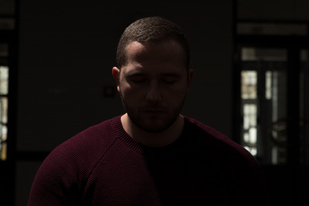 Muslim Man Making Traditional Prayer To God Allah In Dark Roomの写真素材