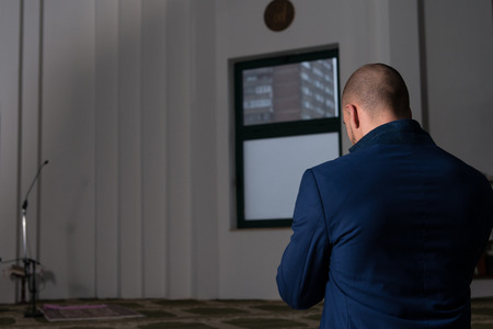 Businessman Muslim Making Traditional Prayer To God Allah In The Mosqueの写真素材