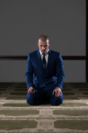 Businessman Muslim Making Traditional Prayer To God Allah In The Mosqueの写真素材