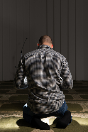 Young Muslim Man Making Traditional Prayer To God Allahの写真素材