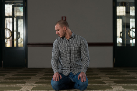 Young Muslim Man Making Traditional Prayer To God Allahの写真素材