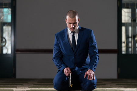 Businessman Muslim Making Traditional Prayer To God Allah In The Mosqueの写真素材