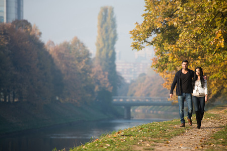 Couple Walking In Forest Through The Woods Outside During Autumnの写真素材