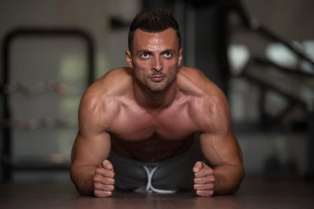 Young Man Athlete Doing Pushups As Part Of Bodybuilding Training
