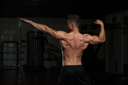 Portrait Of A Physically Fit Man Posing In Modern Fitness Center Gymの写真素材