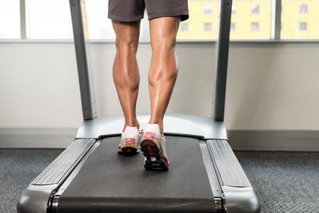 Close Up Of Male Legs Running On Treadmill - Blurred Motion