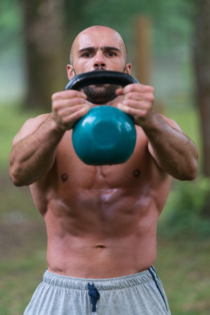 Young Fitness Male Exercise With Kettle Bell - Kettlebell Swingの写真素材
