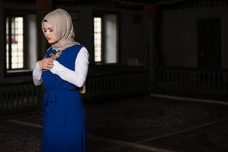 Humble Muslim Woman Is Praying In The Mosque
