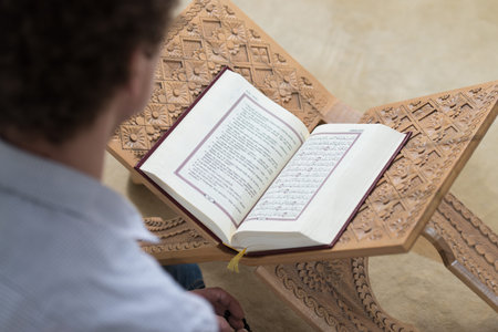 Young Muslim Man Is Reading The Koran In The Mosque - Afro Lock Hair Curly
