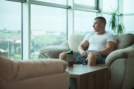 Muscular Man Resting After Exercise And Drinking From Shakerの写真素材