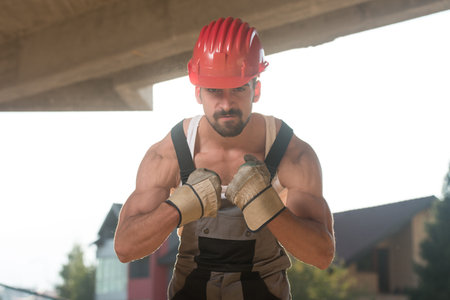Portrait Of Handsome Male Architect Engineer With Red Helmet