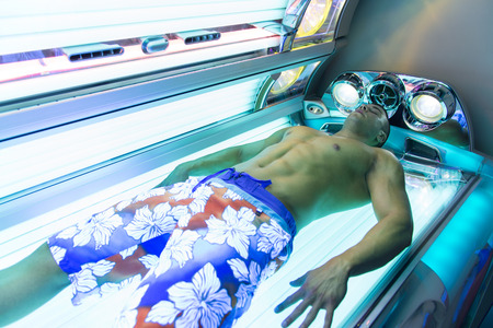 Young Muscular Man At Solarium In Beauty Salonの写真素材