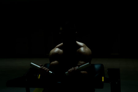 Siluet Young Bodybuilder Doing Heavy Weight Exercise For Biceps On Machine