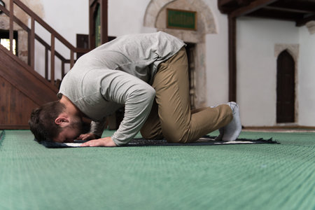 Adult Muslim Man Is Praying In The Mosque