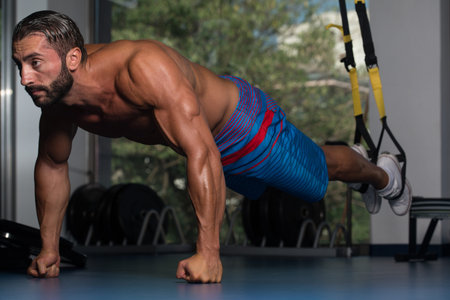 Italian Adult Athlete Doing Push Ups As Part Of Bodybuilding Training With Trx Fitness Straps