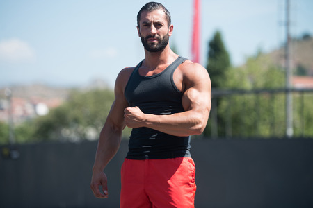 Portrait Of A Physically Fit Young Man Posing Outdoorsの写真素材