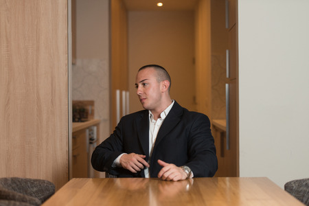 Portrait of a Handsome Young Man in Suit and Tie Resting at Homeの写真素材