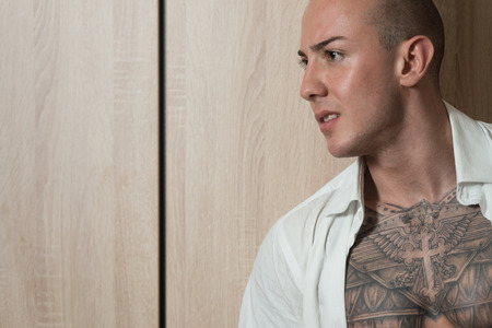 Portrait of a Successful Young Man Standing Isolated on Wood Backgroundの写真素材